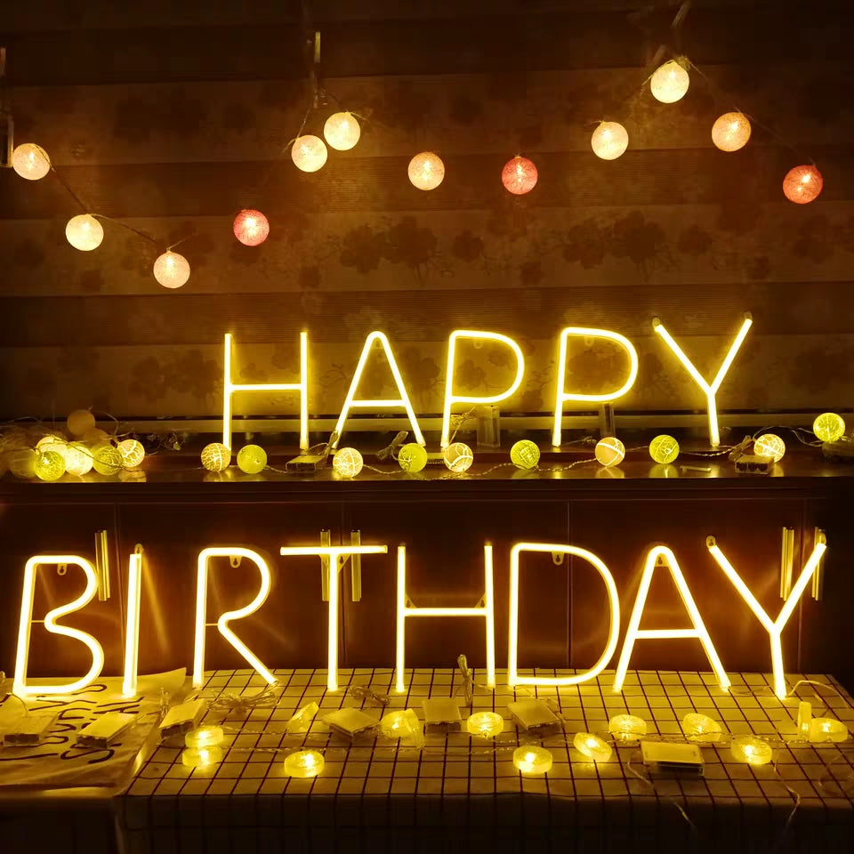 LED meteor firecracker lights spelling out Happy Birthday with glowing lights.